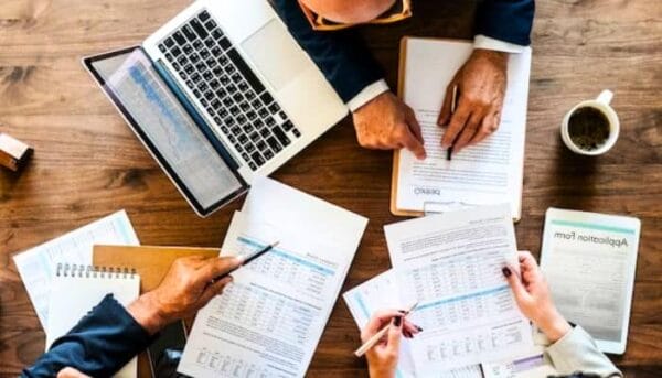 cannabis business owner sitting down to handle cannabis bookkeeping with a cannabis accounting professional